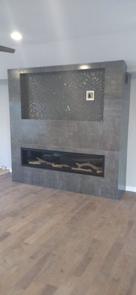 Tile and finishing for a gray modern fireplace